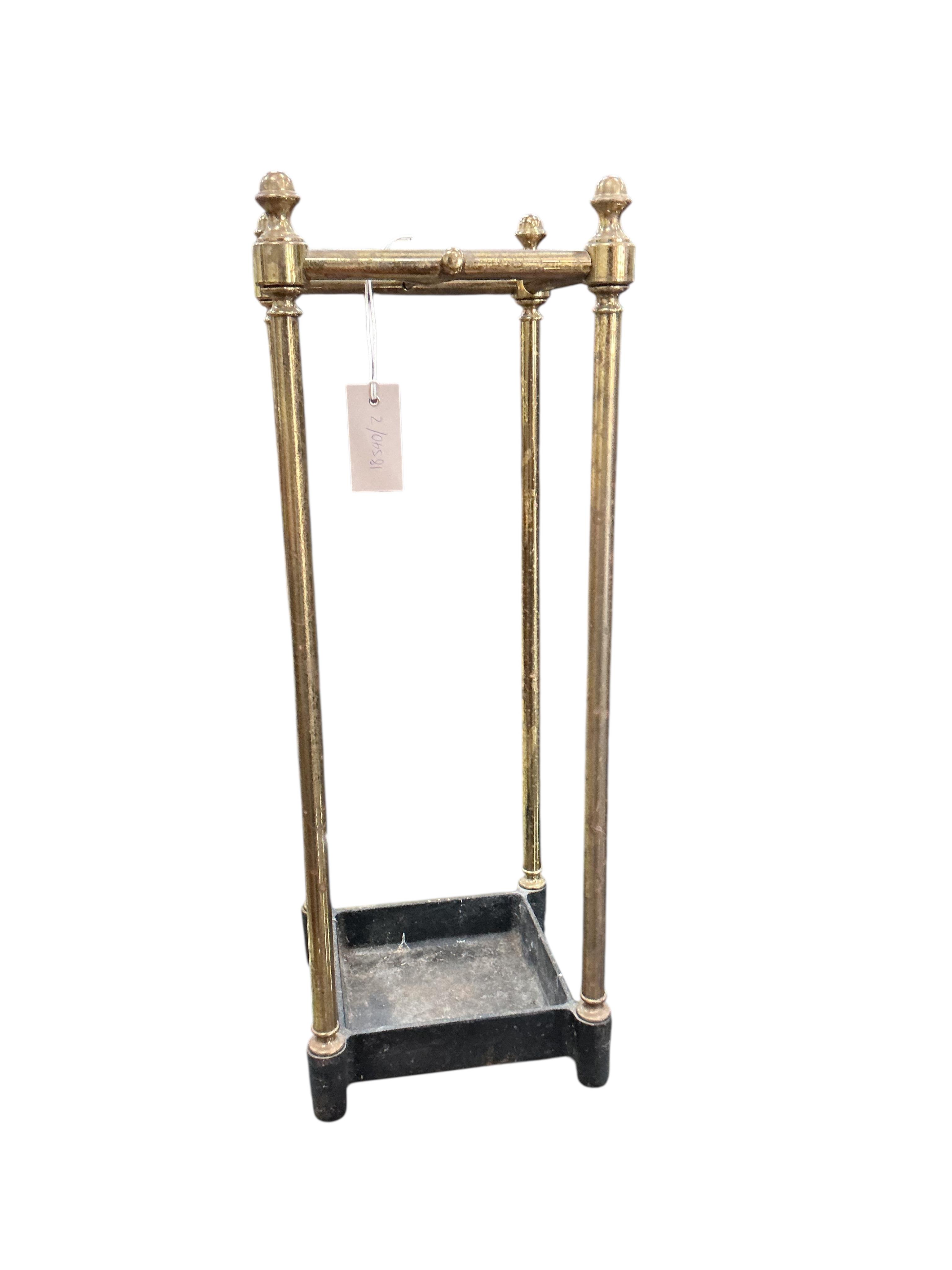 A brass and cast iron four division stick stand, width 21cm, height 59cm